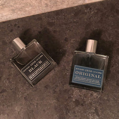 Tru Fragrance Beauty 1956 Black bottle on a stylish display.