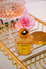 Truly Vanilla Baby EDP bottle being poured to illustrate layering potential