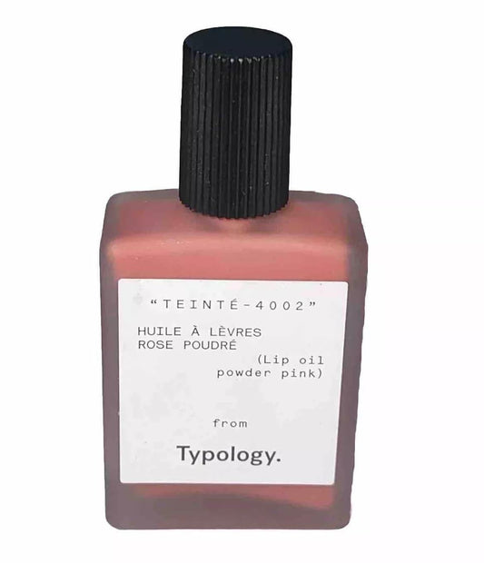 Typology Tinted Lip Oil Powder Pink delivers nourishing shine.