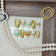 UNIYVOH golden charms and drips on nails offer luxe detail and sparkle.
