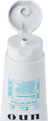 UNO WHIP WASH exfoliating beads visible, helping clarify pores.