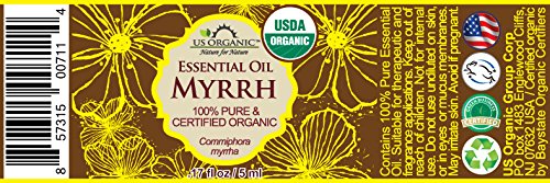 Close-up of US Organic Myrrh essential oil bottle label for clarity.