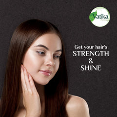 Vatika Naturals Dabur Enriched Black Seed Hair Oil in hand for easy application.