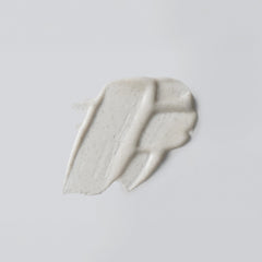 Versed Buff It Out texture close-up highlights microfine pumice for gentle exfoliation.