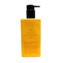 Victoria's Secret Bombshell Amalfi Lotion bottle bathed in sunlight highlights fresh citrus and coastal notes