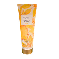 Victoria's Secret Pineapple and Shea Glow bottle for long-lasting moisture and glow.