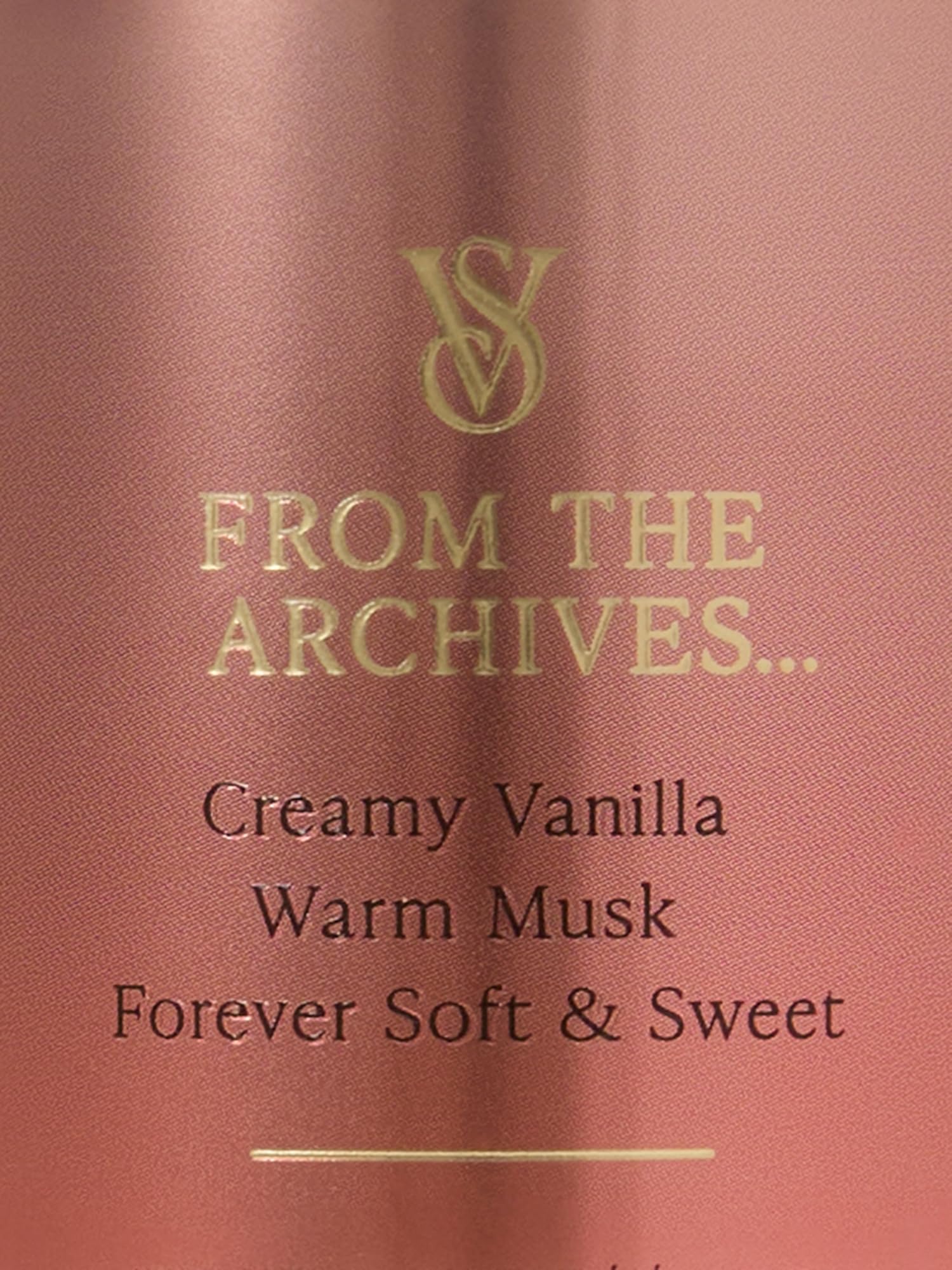 Hands applying Victoria's Secret Vanilla Lace mist for a soft, warm aroma.