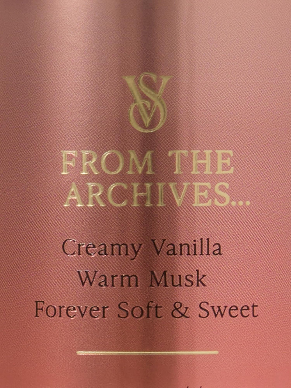 Hands applying Victoria's Secret Vanilla Lace mist for a soft, warm aroma.