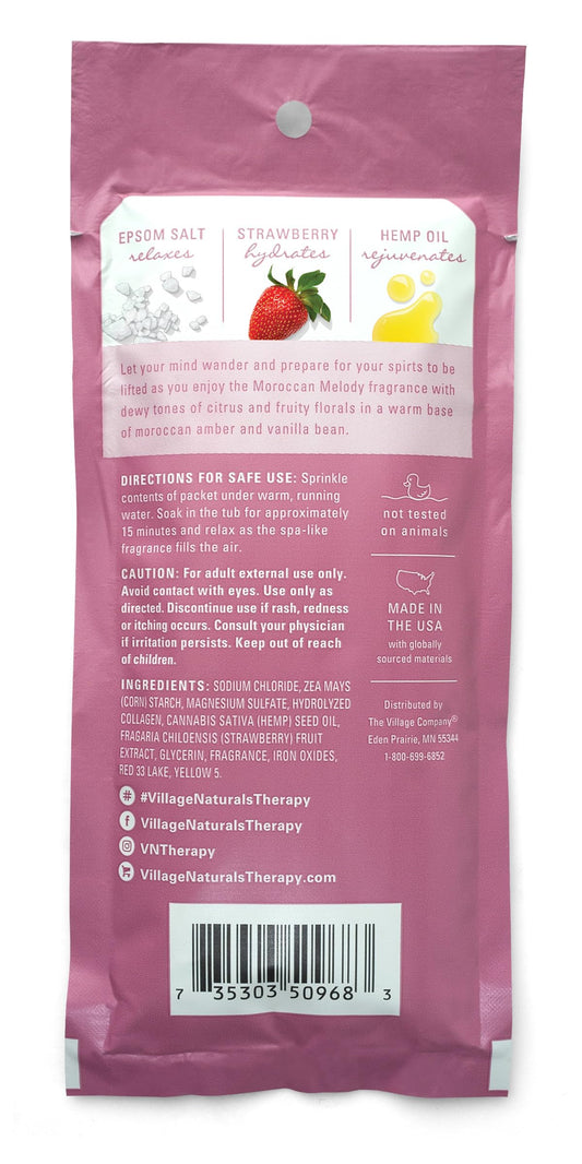 Village Naturals Therapy Glow bottle close-up highlights citrus-rose scent and nourishing minerals.