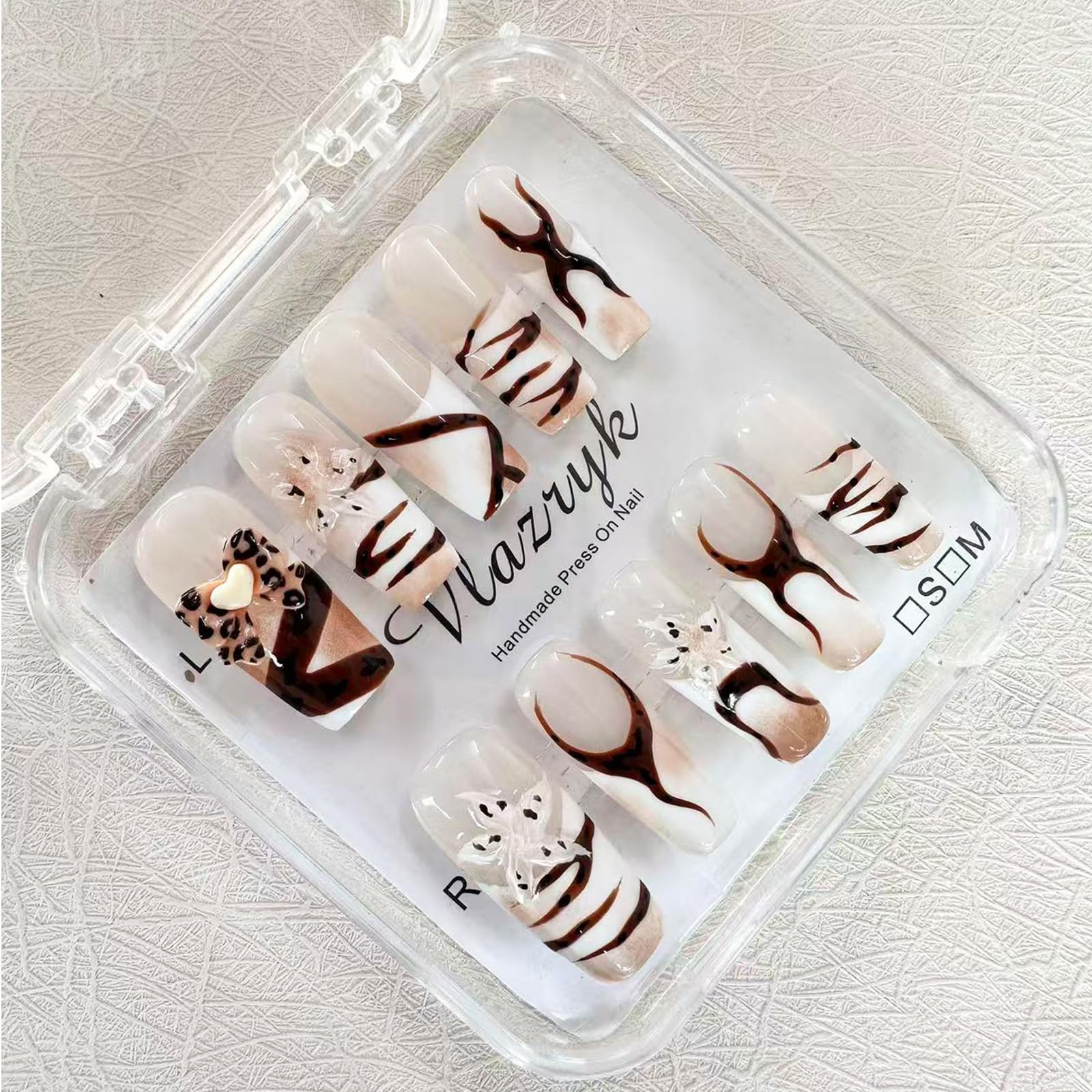 Vlazryk long-square mid-length nails with a sleek French tip for everyday style.