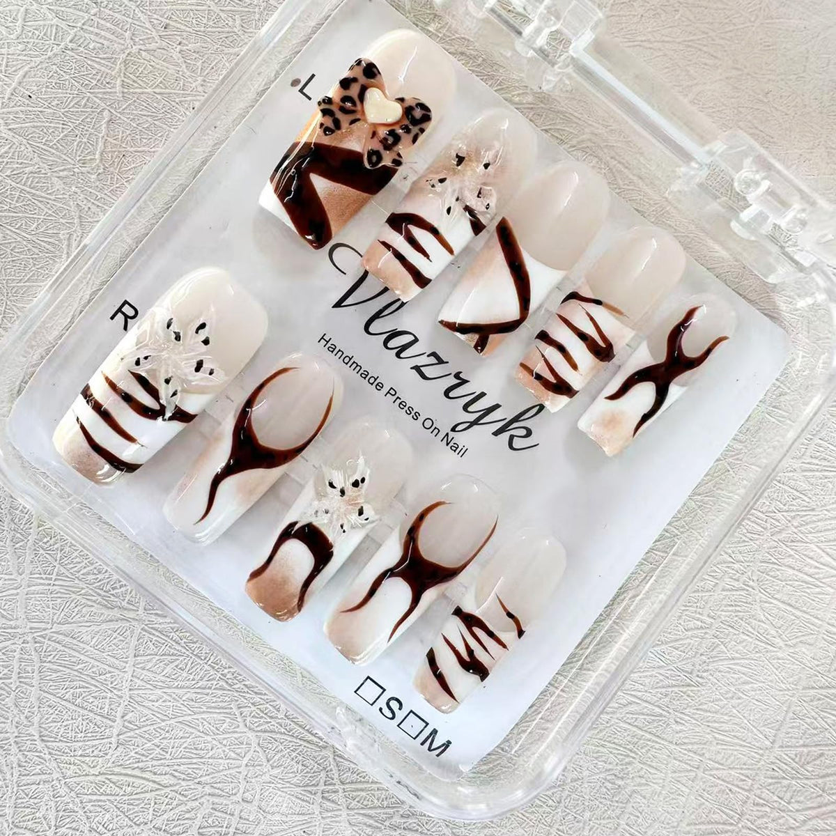 Vlazryk nails with stars and leopard 3D embossed nails for an easy at-home glamorous look.