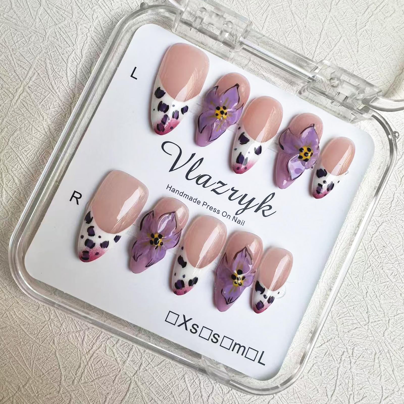 Vlazryk purple French almond nails with 3D flowers for at-home elegance.