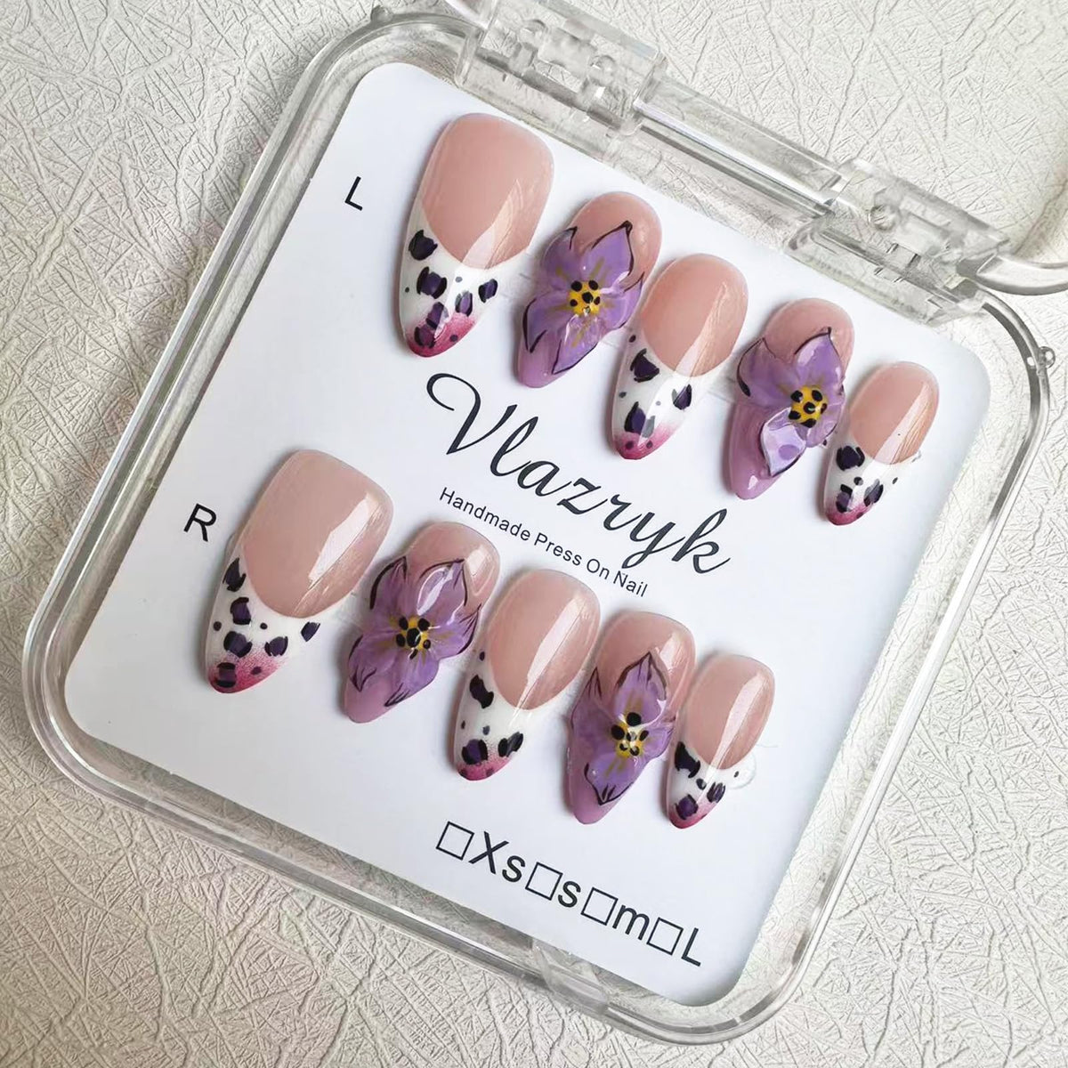 Vlazryk purple French almond nails with 3D flowers for at-home elegance.