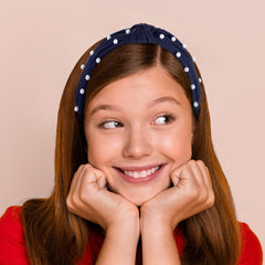 VOCOSTE satin-knotted headband closeup pearls reveal refined detail for special occasions.