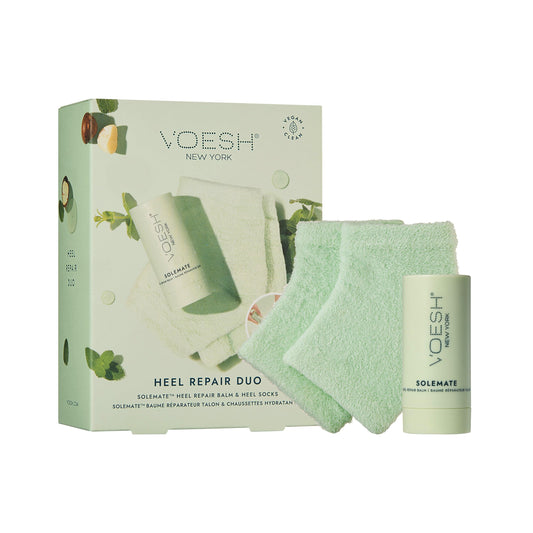 VOESH Solemate Heel Repair Balm stick in hand for quick hydration.