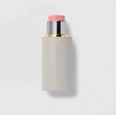 Westman Atelier Baby Cheeks Blush Stick Coquette swatch shows buildable pinky-peach glow.