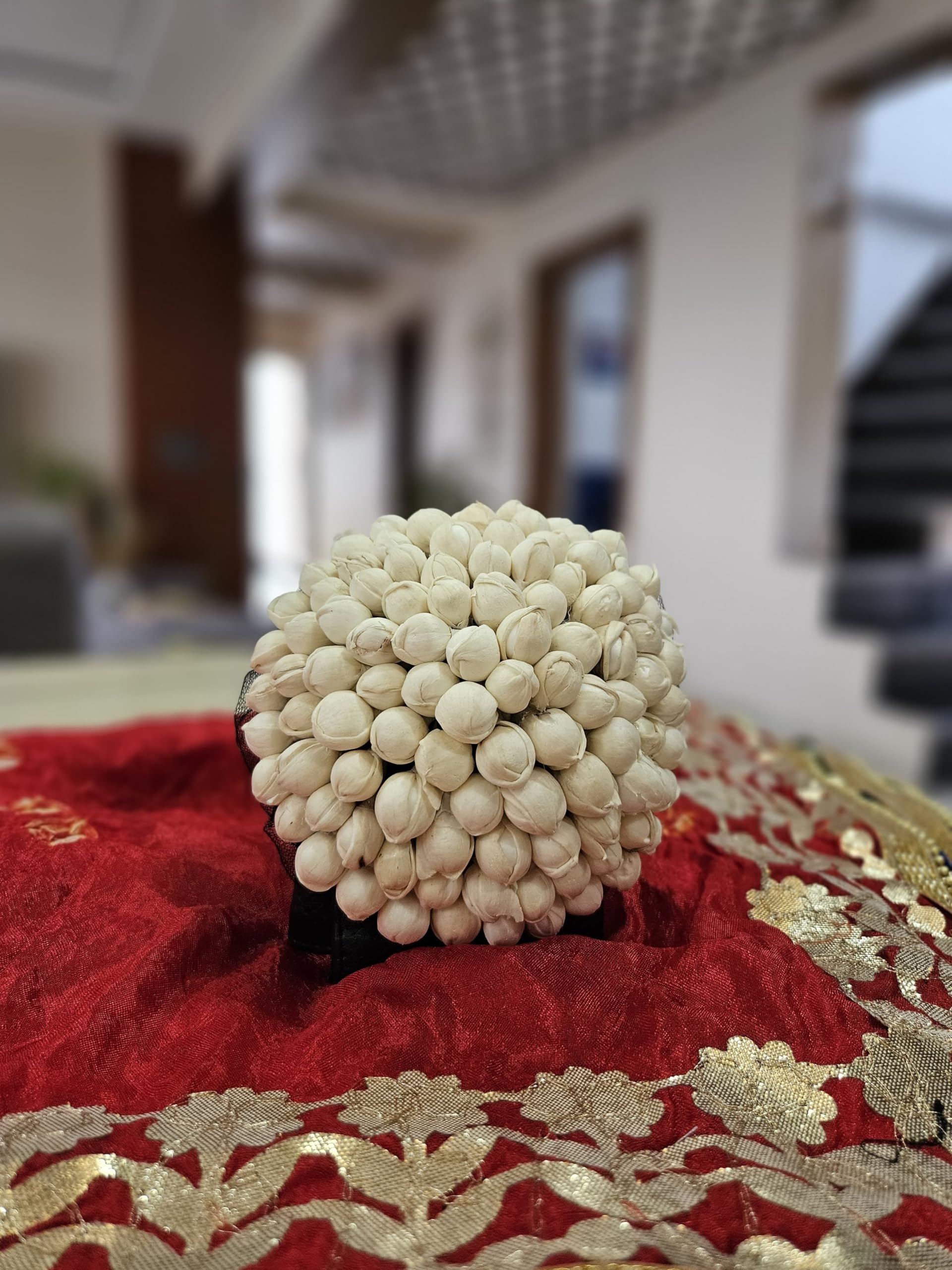 White gajra hair adornment for festive occasions, keeps hairstyle in place.
