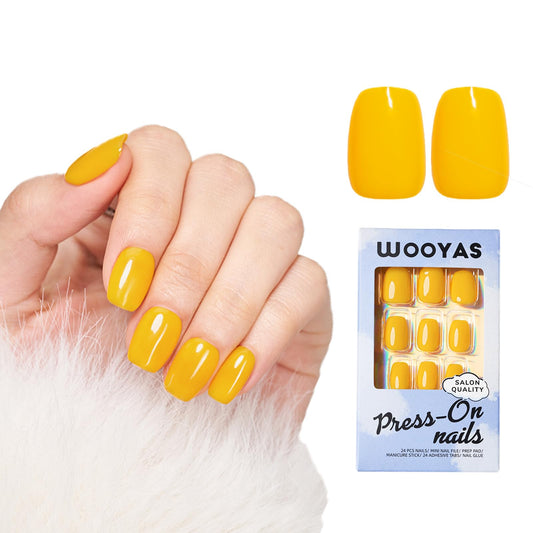 Wooyas yellow short press on nails with glossy gel finish.