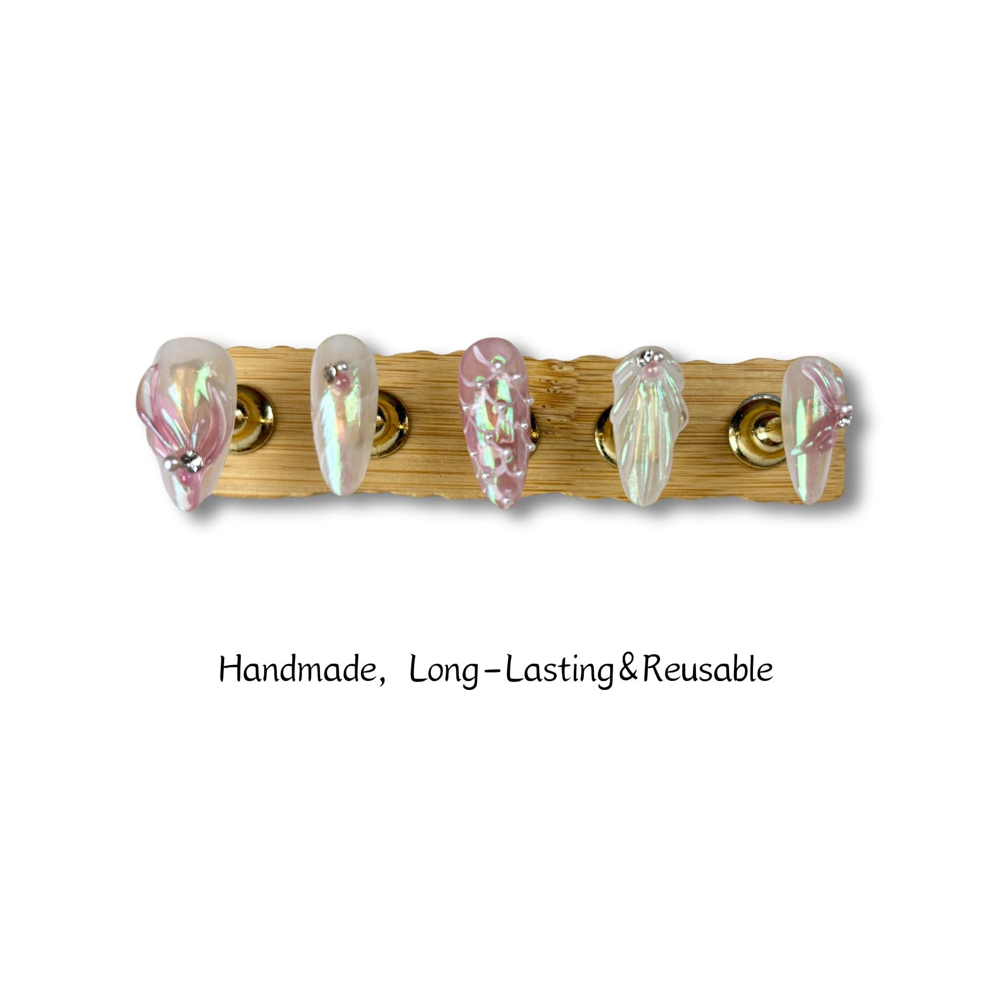 Close-up of Yabonica almond press-on nail showing 3D design and shimmering cat-eye finish