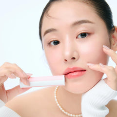 YNM Peach Soda lip plumper on lips delivers subtle hydration and shine.