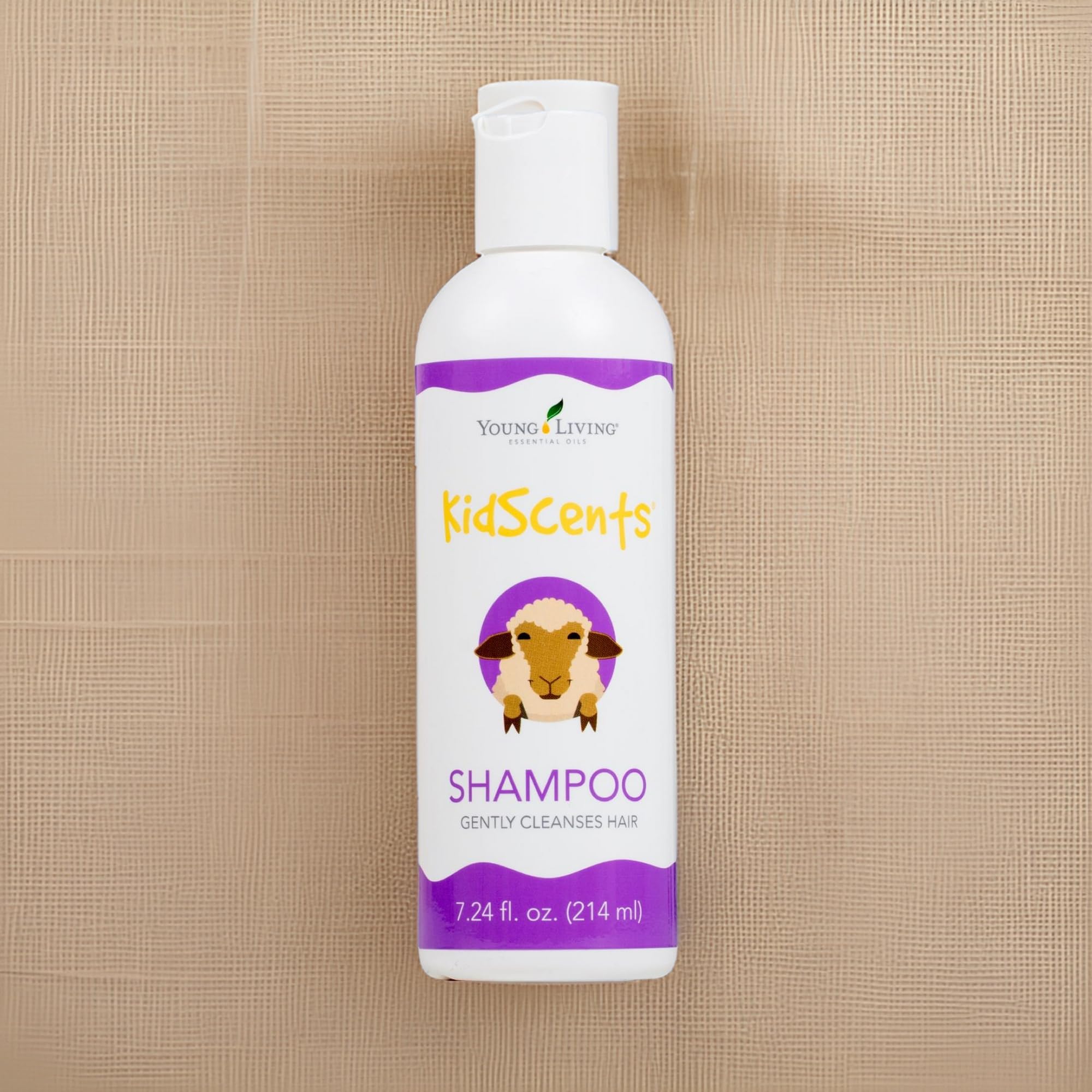 Young Living KidScents Shampoo with water droplets signals hydration and freshness.
