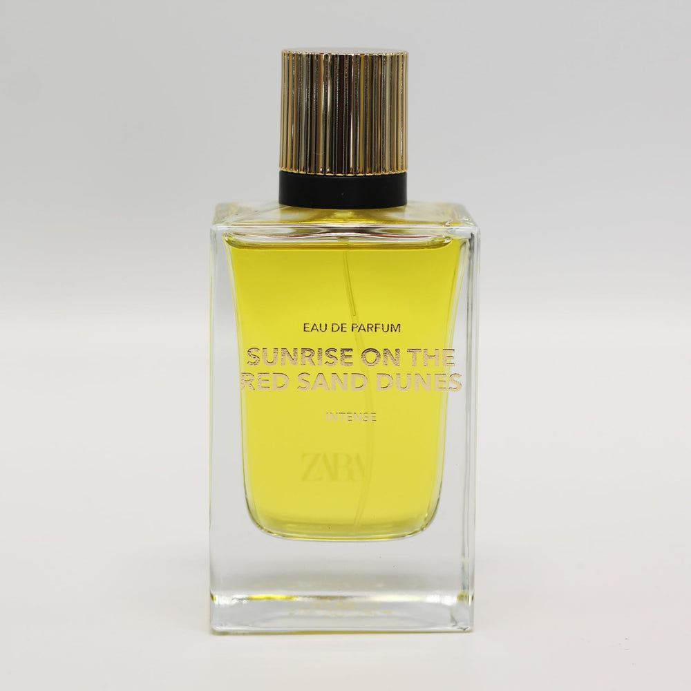 Zara Sunrise EDP at dawn on dunes, bright daytime wear.