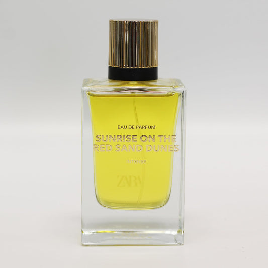 Zara Sunrise EDP at dawn on dunes, bright daytime wear.